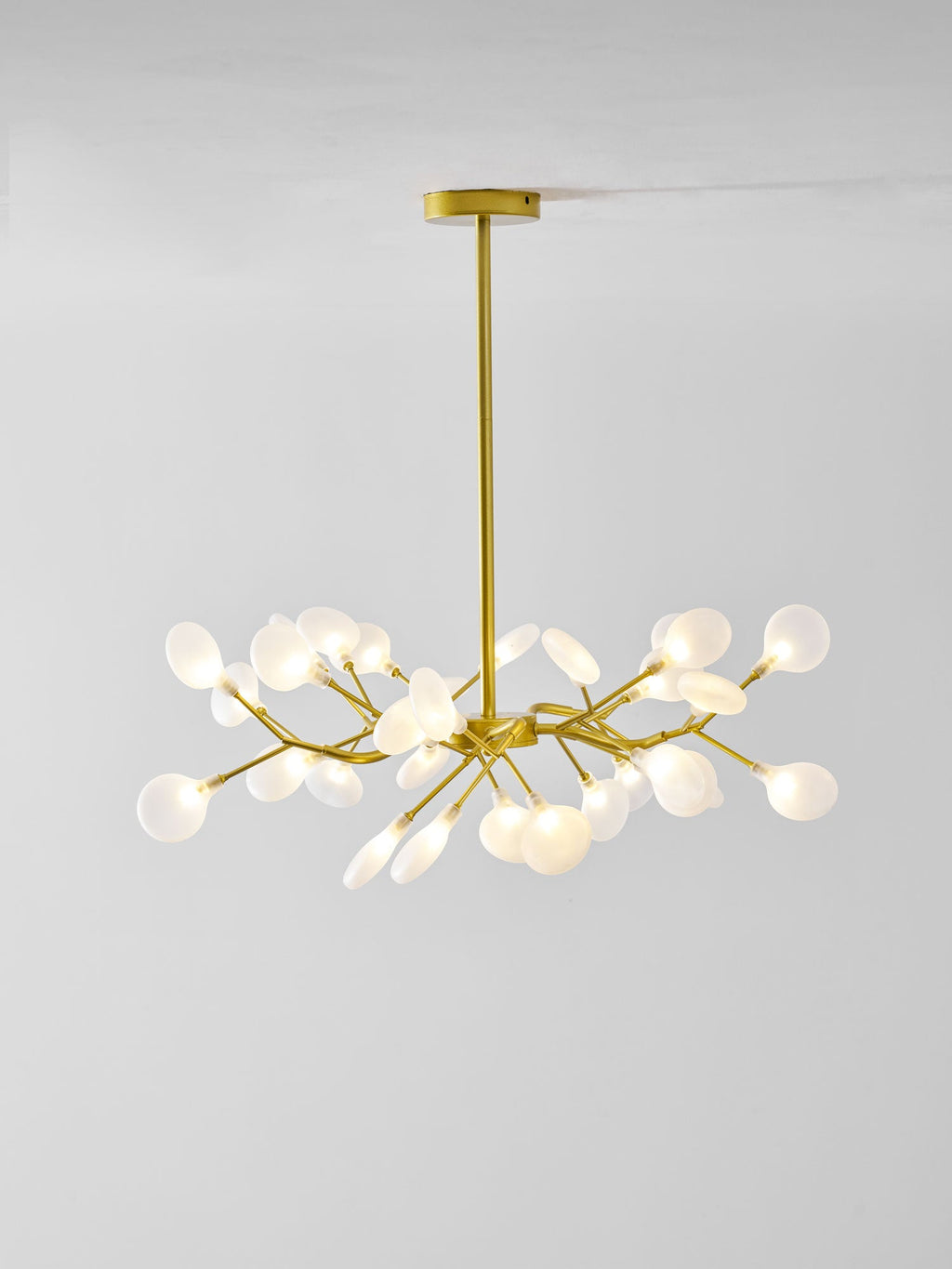 Sputnik chandelier with many glass leaves glowing softly