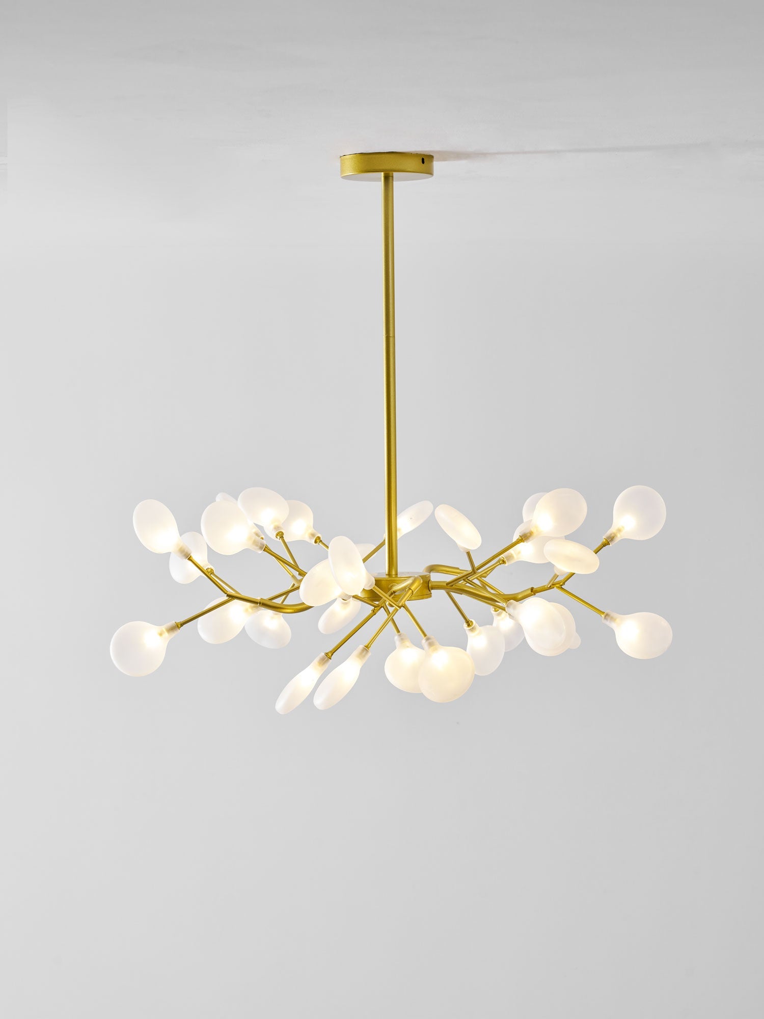 Sputnik chandelier with many glass leaves glowing softly