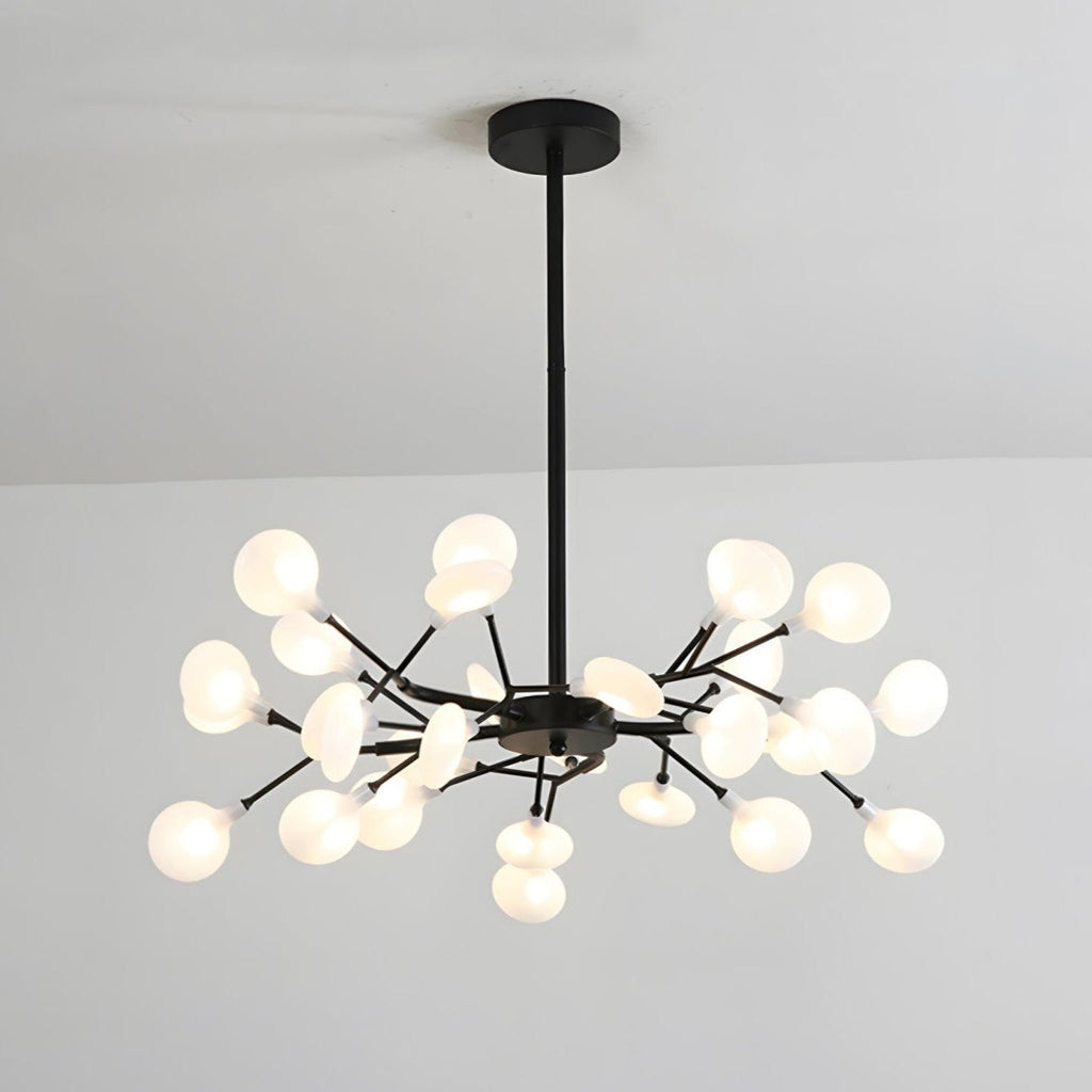 Sputnik chandelier radiating warm light from glass leaves