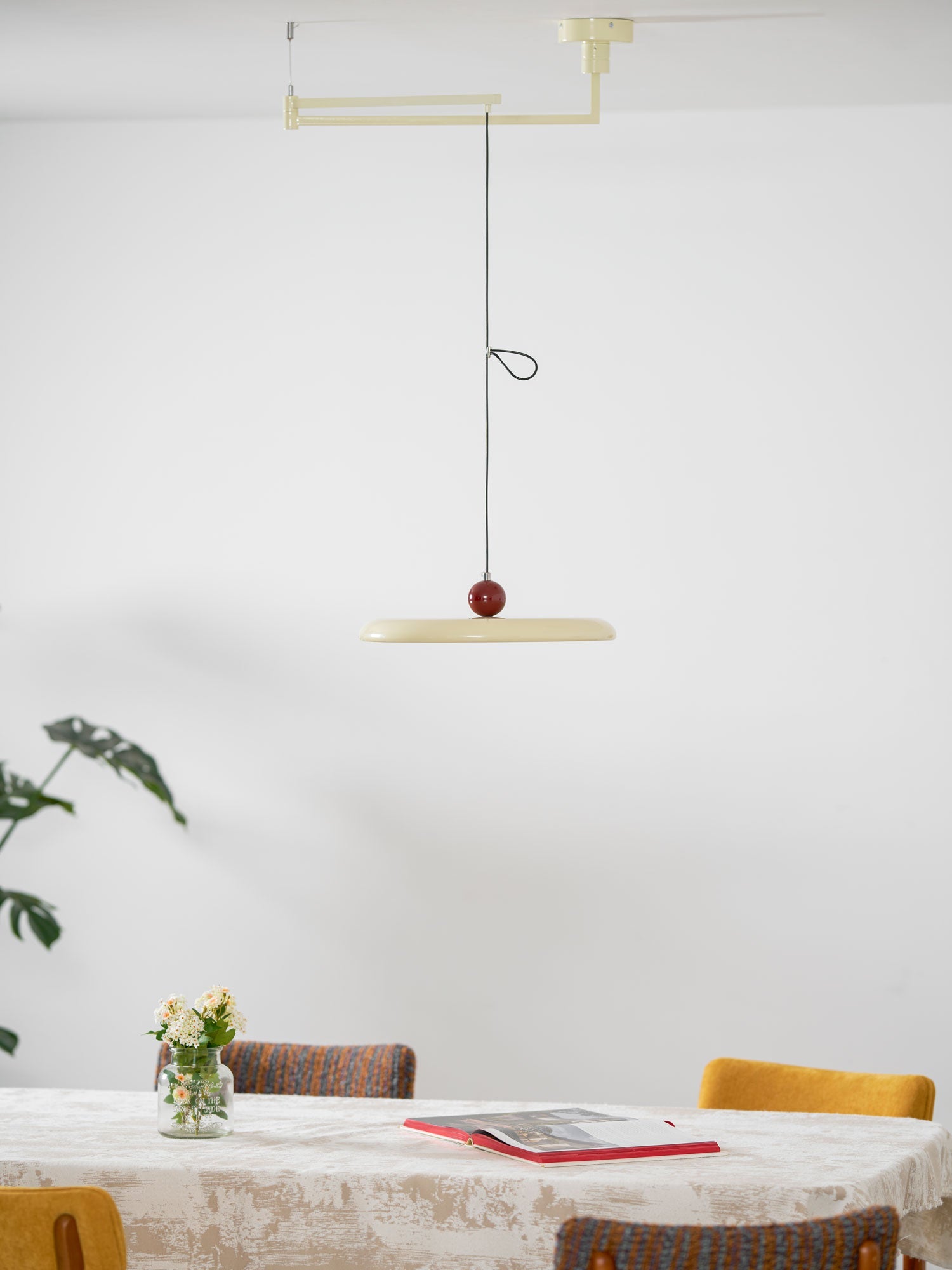 Mid-century disc pendant light on an articulating swing arm