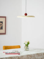 Mid-century pendant light with lit disc balanced by a round weight