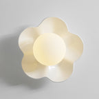 Its ball lit, this Clérachic wall light in a pale cream finish sits against a plain grey backdrop.