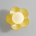 Close studio shot of this Clérachic wall light in yellow with its ball lit, against a plain grey backdrop.
