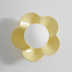 In a plain studio shot, this Clérachic wall light in yellow sits unlit against a grey backdrop.