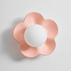 Against a plain grey backdrop, this Clérachic wall light in pink sits unlit and centred in the frame.