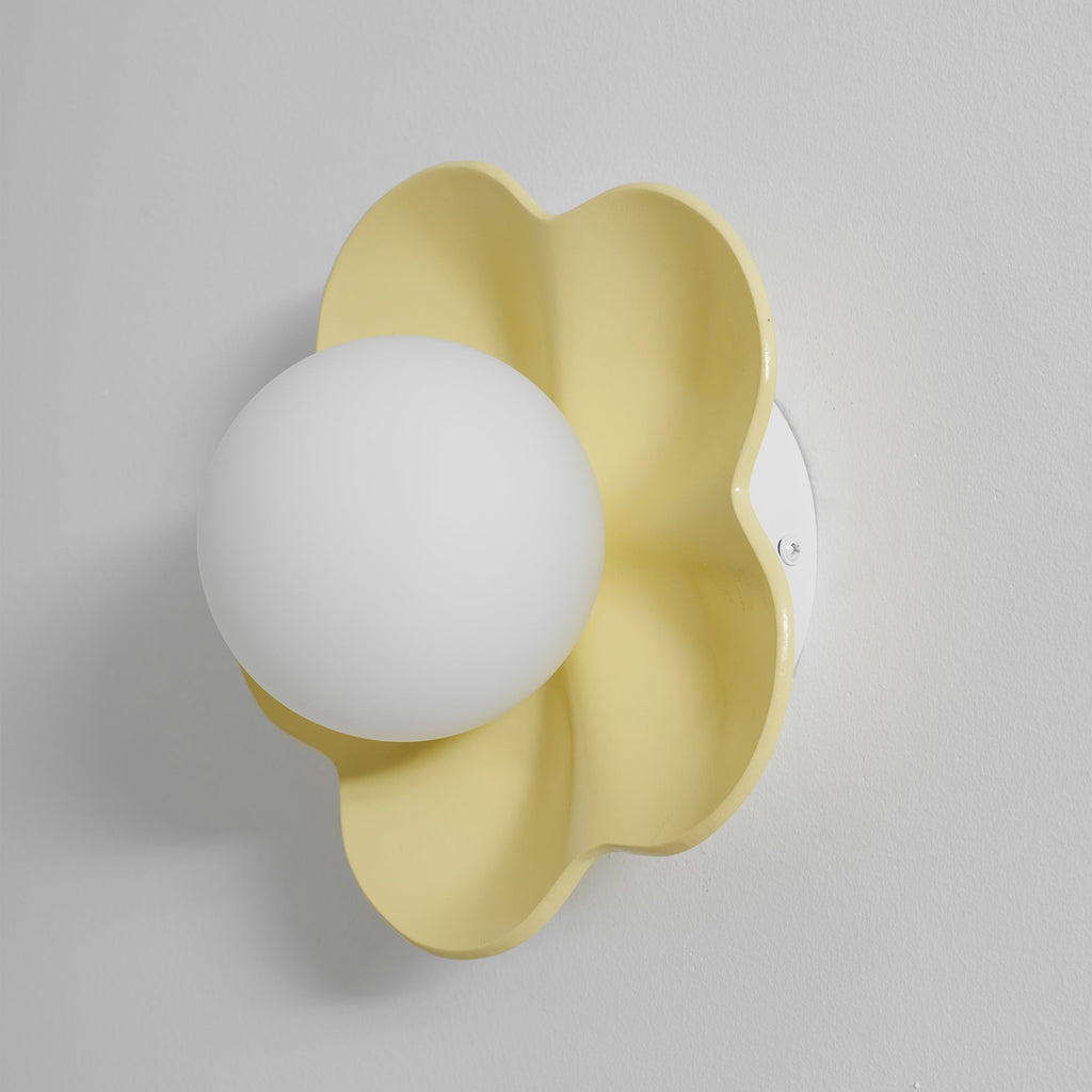 Mounted close against the wall with its ball unlit, this Clérachic wall light in yellow fills the frame.