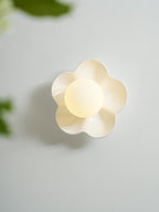 With a blurred leaf crossing the foreground, this Clérachic wall light in white glows on the wall.
