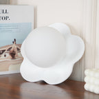 A larger close view of this Clérachic wall light in white on the tabletop, its petals filling the frame.