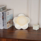 A smaller, more distant view of this Clérachic wall light in white, lit, on the same tabletop.