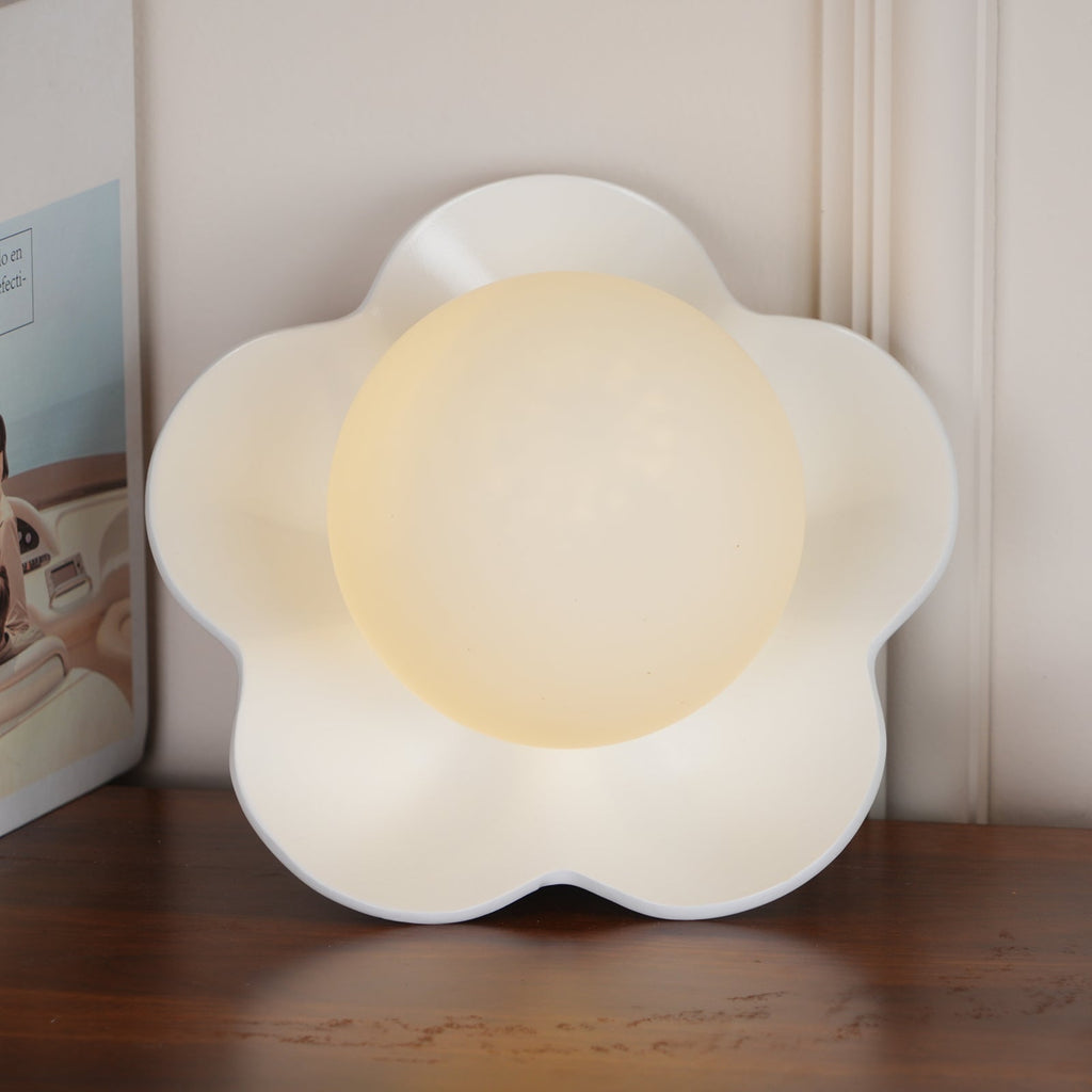A close view of this Clérachic wall light in white with its ball lit, filling most of the frame.