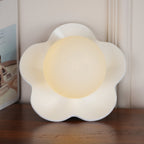 A close view of this Clérachic wall light in white with its ball lit, filling most of the frame.
