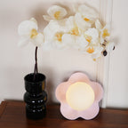 A third angle of this Clérachic wall light in pink, orchid blooms arching overhead on the table.