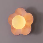 Shot straight on, this Clérachic wall light in pink sits unlit against a plain grey backdrop.