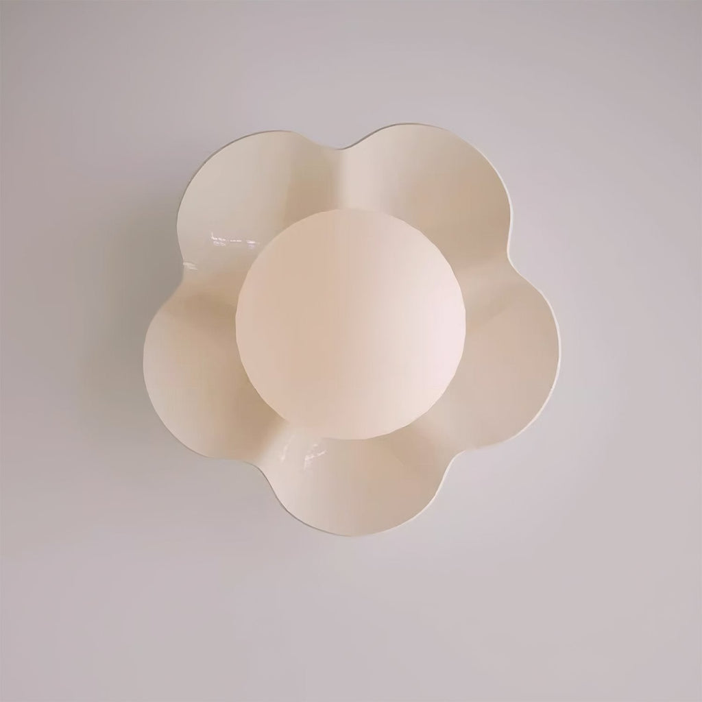 Shot straight on, this Clérachic wall light in a blush tone sits unlit against a lavender-grey backdrop.