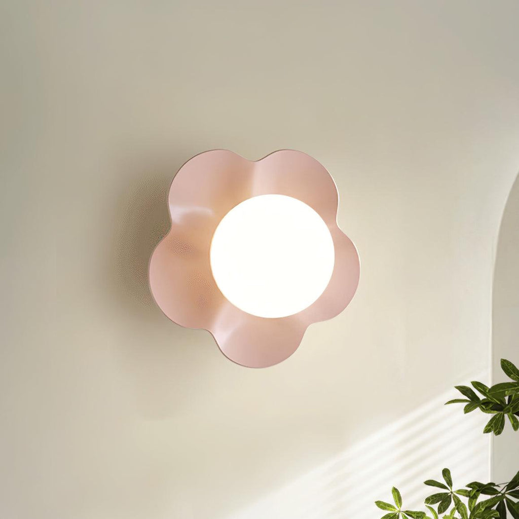 Near an archway with a plant in the foreground, this Clérachic wall light in pink is mounted on the wall.