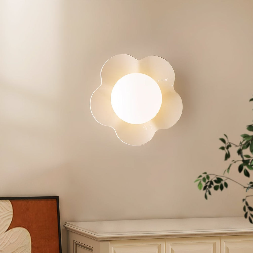 Mounted above a cabinet in a wall corner, this Clérachic wall light in white sits near a leafy plant.