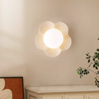 Mounted above a cabinet in a wall corner, this Clérachic wall light in white sits near a leafy plant.