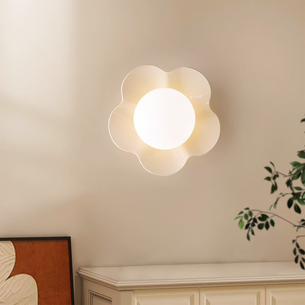 Above a pale cabinet with a leafy plant nearby, this Clérachic wall light in white sits mounted on the wall.