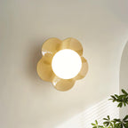 With greenery in the corner of the frame, this Clérachic wall light in a pale tan finish is mounted on the wall.