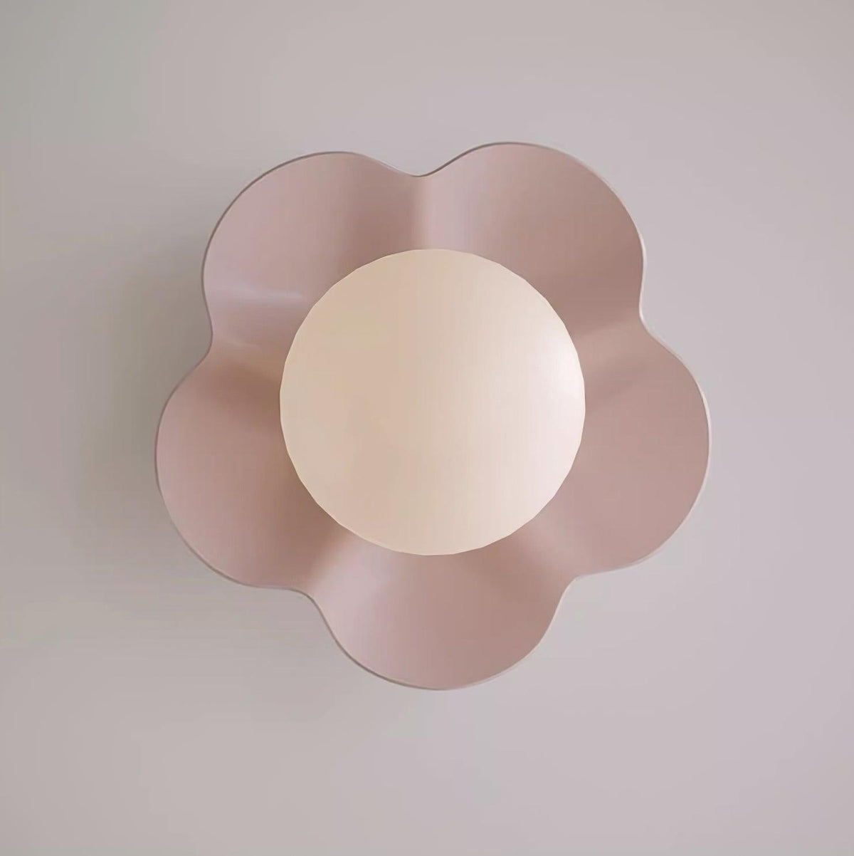 Photographed head-on, this Clérachic wall light in pink sits unlit against a plain grey backdrop.