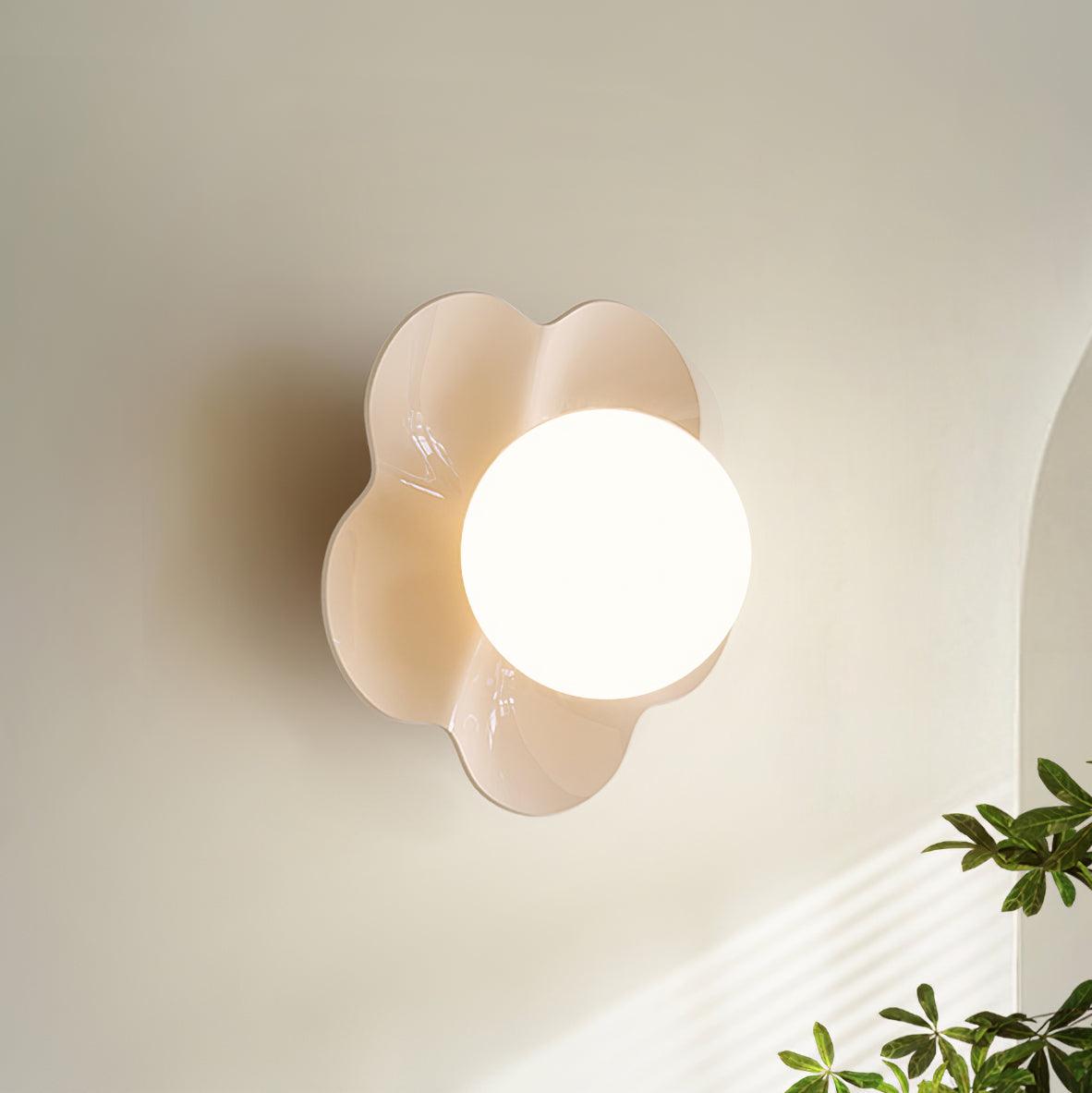 Near an archway with a plant in the corner, this Clérachic wall light in white glows softly.