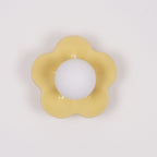 In a plain studio shot, this Clérachic wall light in a paler yellow sits unlit against a white backdrop.