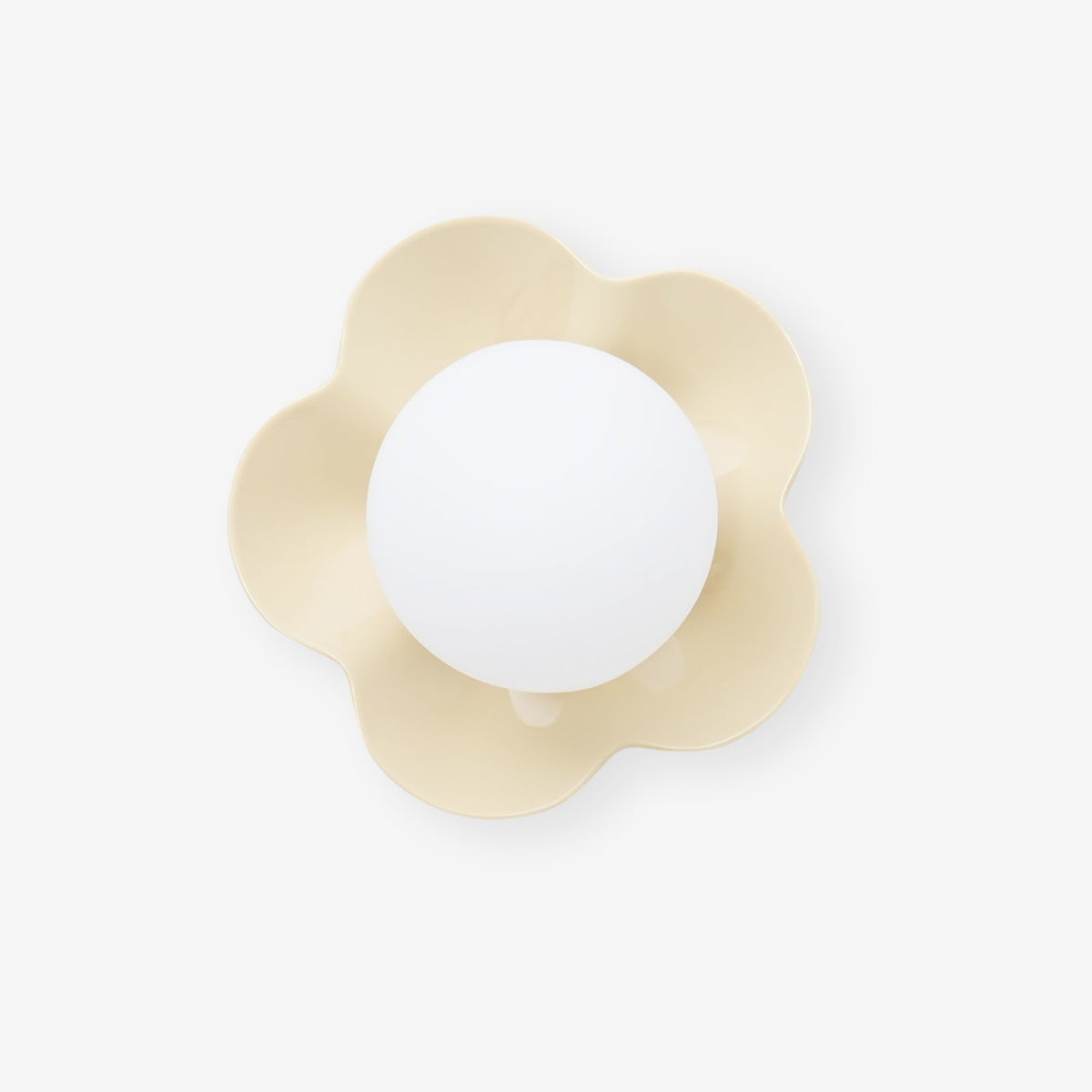 Seen straight on, this Clérachic wall light in a pale cream finish sits unlit against a white backdrop.