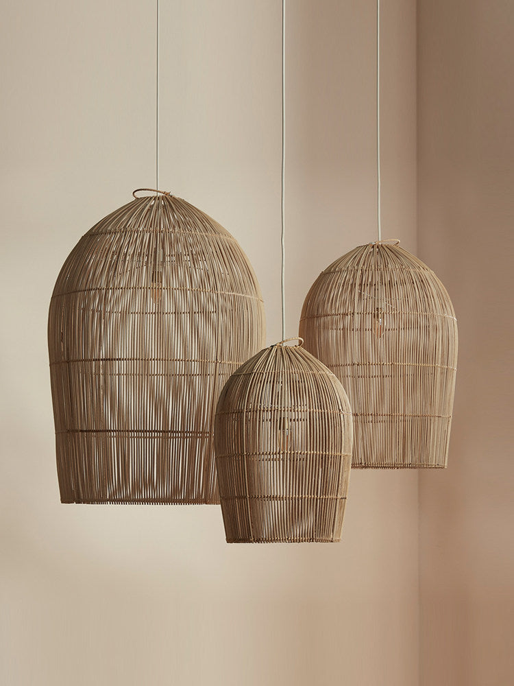 Three sizes of this Clérachic pendant hang together against a plain wall.
