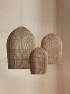 Three sizes of this Clérachic pendant hang together against a plain wall.