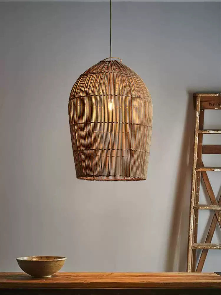 This Clérachic pendant hangs against a plain grey wall near a wood ladder and a small bowl on a shelf.