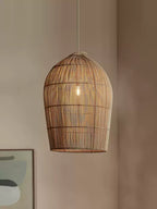 This Clérachic pendant hangs against a plain wall, the edge of an abstract framed print visible below.