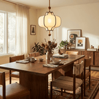 Lantern pendant light with white shade over a bedside setting