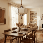 White lantern pendant light with gold frame over an entryway