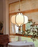 Lantern pendant light glowing above a styled dining space