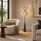 The same cream boucle armchair and wood side table, cropped closer so this Clérachic lamp's clustered smoke-glass globes fill the frame.