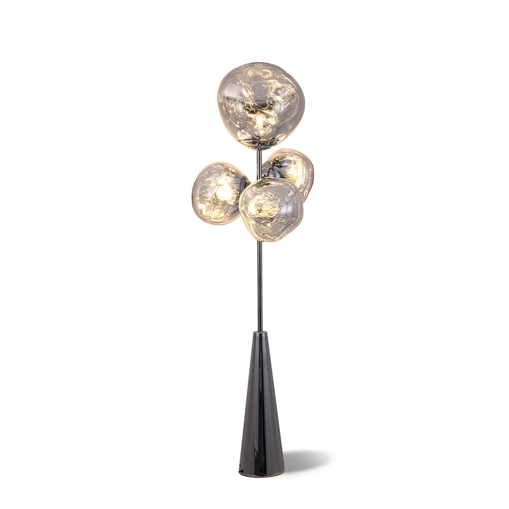 Clérachic floor lamp lit against a plain white backdrop, its smoke-glass globes casting a soft shadow beneath the black conical base.