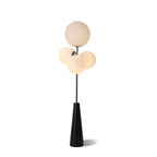 Clérachic floor lamp lit against a plain white backdrop, its frosted white glass globes shown alone with no lifestyle props in frame.