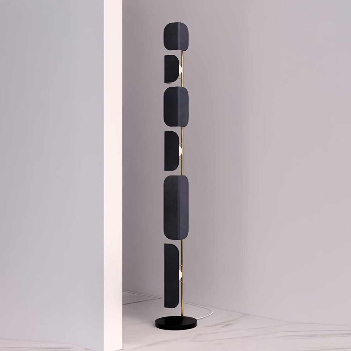 The Clérachic floor lamp stands unlit in a narrow white wall alcove with a marble-look floor.