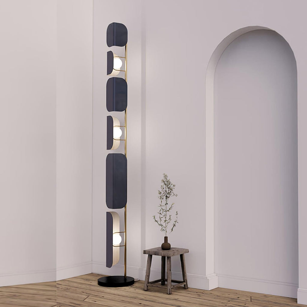 Near an archway, the Clérachic floor lamp glows beside a small wood stool holding a dried branch stem.
