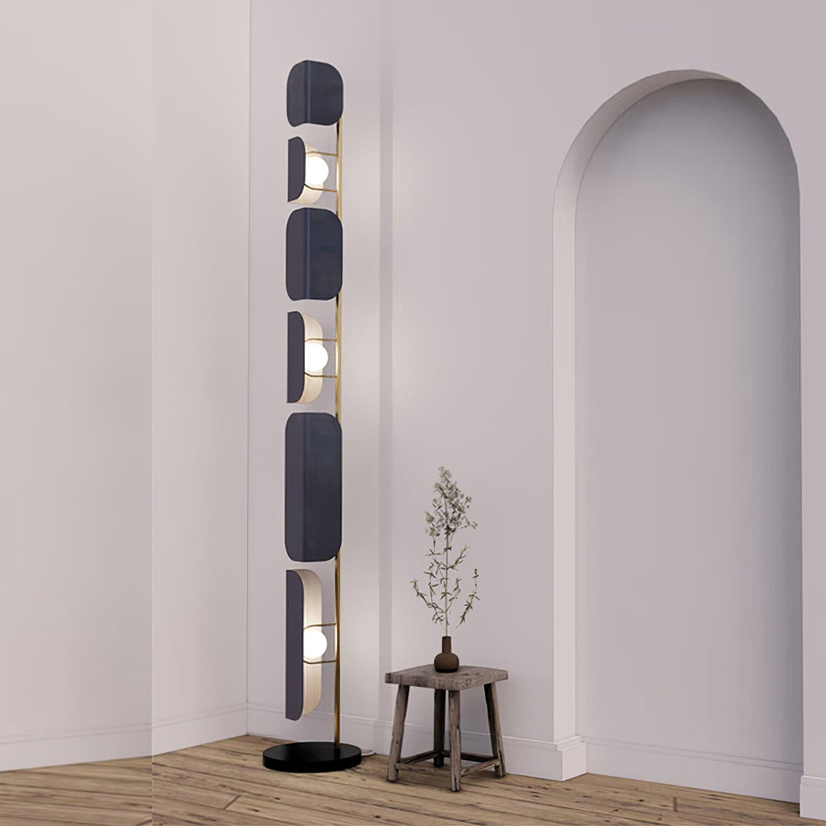 Near an archway, the Clérachic floor lamp glows beside a small wood stool holding a dried branch stem.