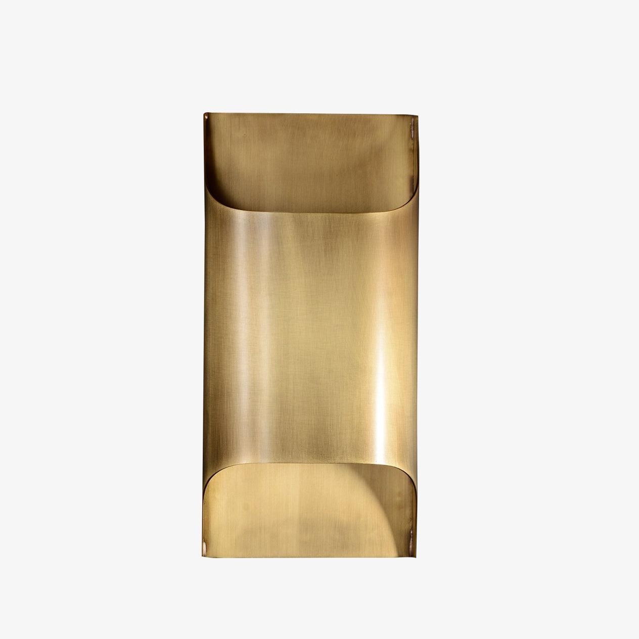 Brass globe wall sconce lit warmly against a neutral wall