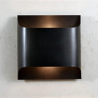 Brass wall sconce detail showing the turned metal body