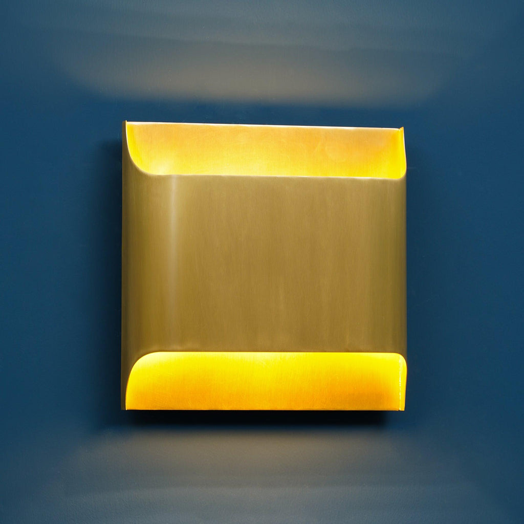 Matte black wall sconce with rounded globe and warm bulb