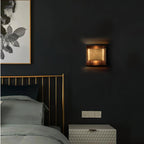 Solid brass wall sconce shown beside a bathroom mirror