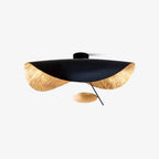 Curved disc ceiling light on a thin rod, lit warm