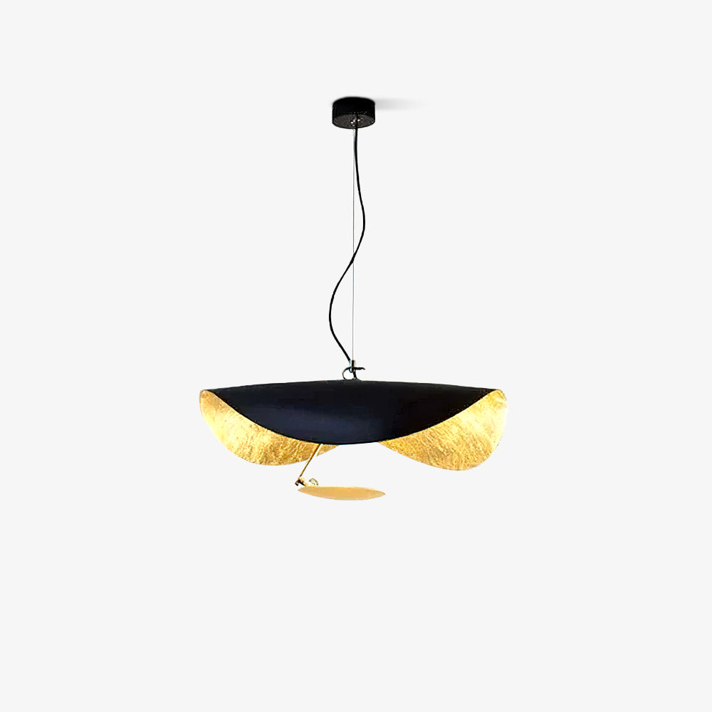 Curved disc pendant light glowing above a console table