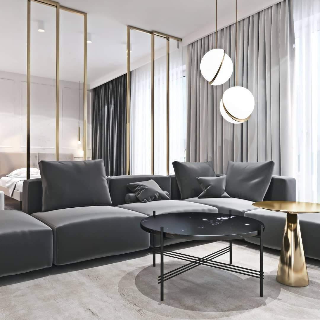Above a grey sectional sofa framed by sheer curtains, two of this Clérachic pendant hang softly lit.