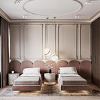 Between two beds on a dusky pink panelled wall, a single opal pendant glows, from Clérachic.