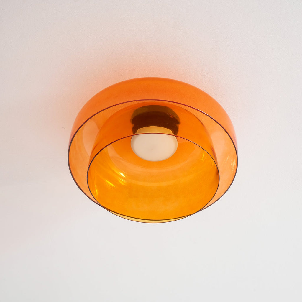 Tinted glass ceiling light shown close against a plain ceiling