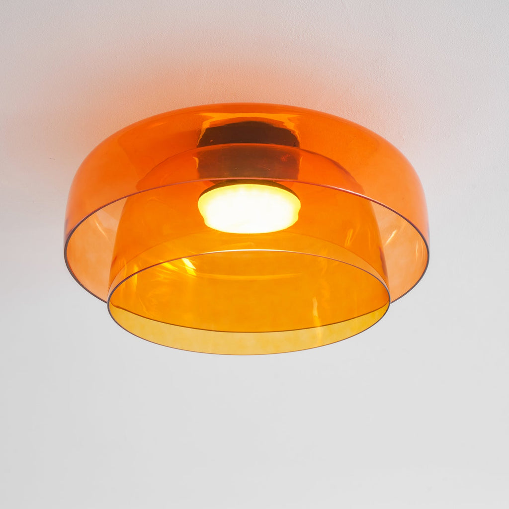 Tinted glass-disc ceiling light mounted flush overhead